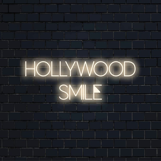 Hollywood Smile Neon Sign, glowing wall decor against black brick wall