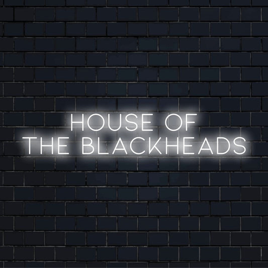 House Of The Blackheads LED Neon Sign, bright neon glow against black brick wall