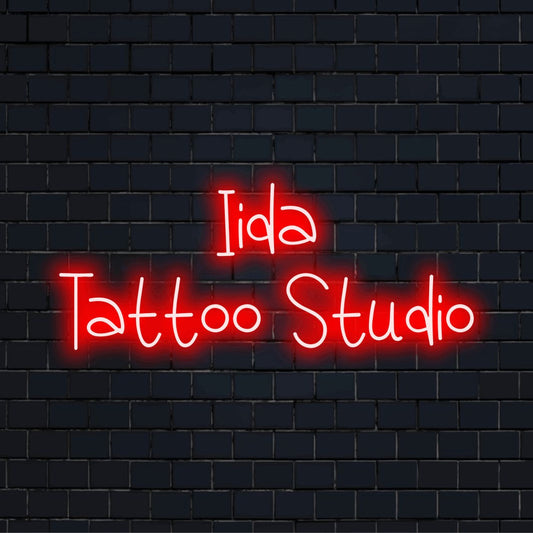 Iida Tattoo Studio Personalized LED Neon Sign, bright neon glow on black brick background