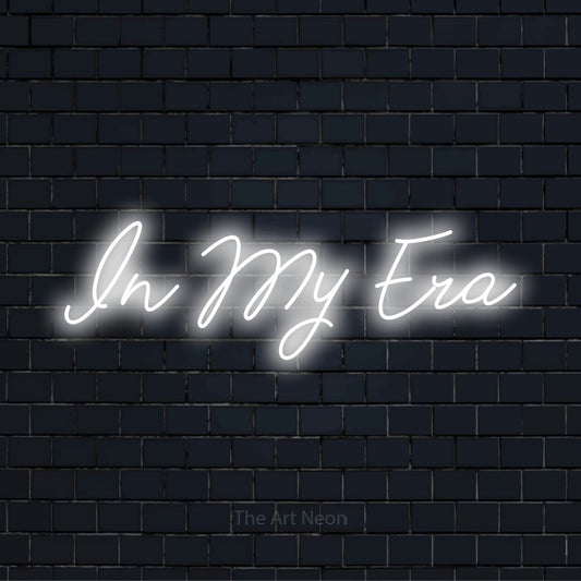 "In My Era" neon text design on a black brick wall