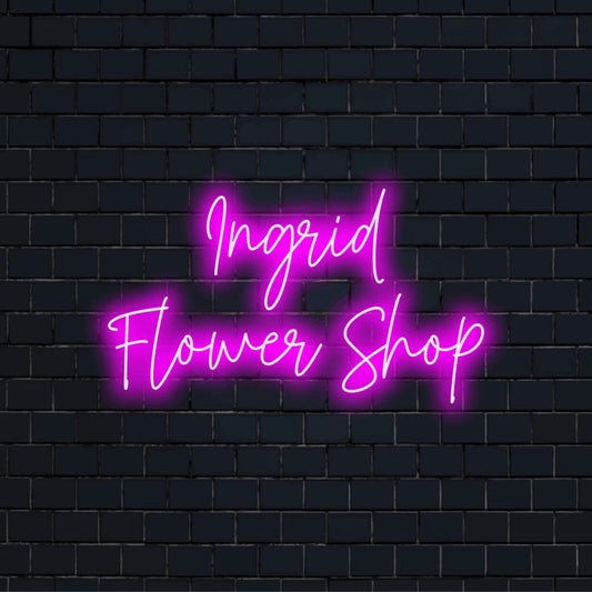 Ingrid Flower Shop Personalized Neon Light with glowing lettering against brick backdrop