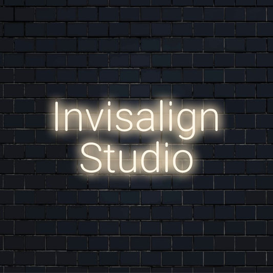 Invisalign Studio LED Neon Sign, bright neon glow against brick backdrop