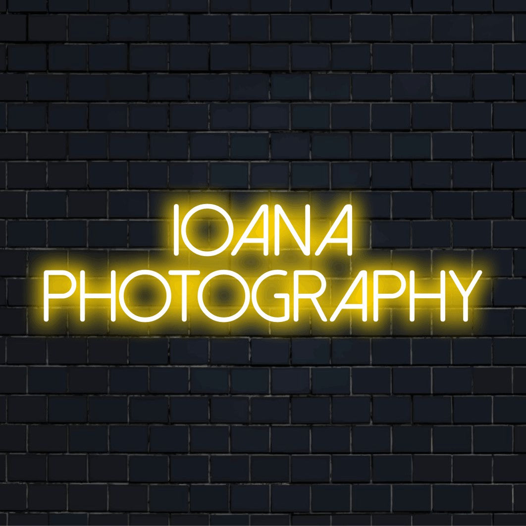 Ioana Photography Custom Name Neon Sign, bright neon glow against brick backdrop