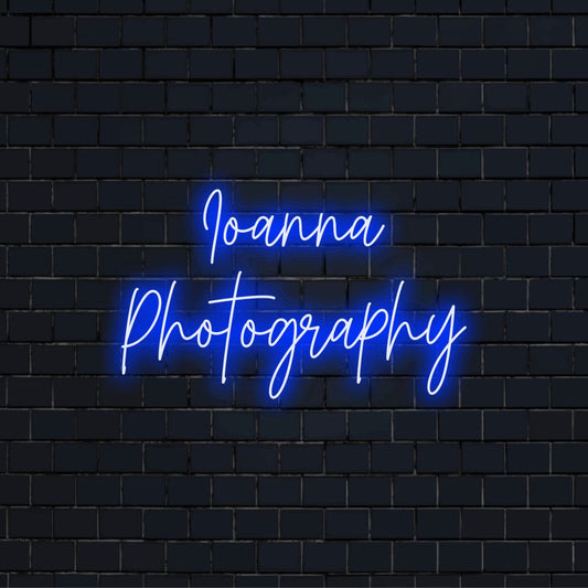 Ioanna Photography Personalized Neon Light with glowing lettering against black brick wall