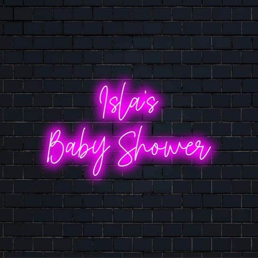 Isla_s Baby Shower Custom Name Neon Sign, bright neon lettering against black brick wall