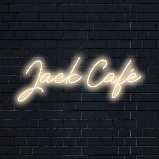 Jack Cafe Personalized Neon Light with bright neon glow against brick backdrop