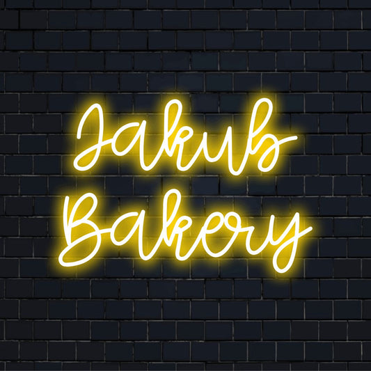 Jakub Bakery Custom Name Neon Sign, soft neon glow on dark brick wall