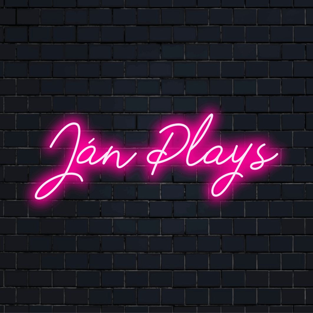 Jan Plays Custom Name Neon Sign, bright neon lettering on black brick background