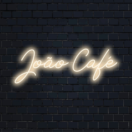 Joao Cafe Personalized LED Neon Sign, bright neon glow against brick backdrop