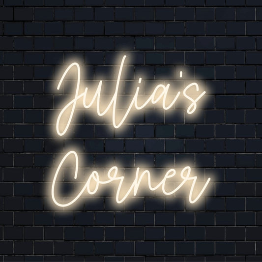 Julia_s Corner Custom Name Neon Sign, glowing wall decor against black brick wall