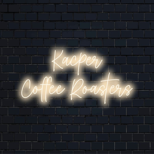 Kacper Coffee Roasters Personalized Neon Light with glowing lettering on black brick background