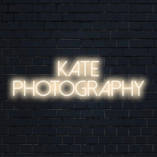 Kate Photography Custom Name Neon Sign, bright neon lettering against brick backdrop