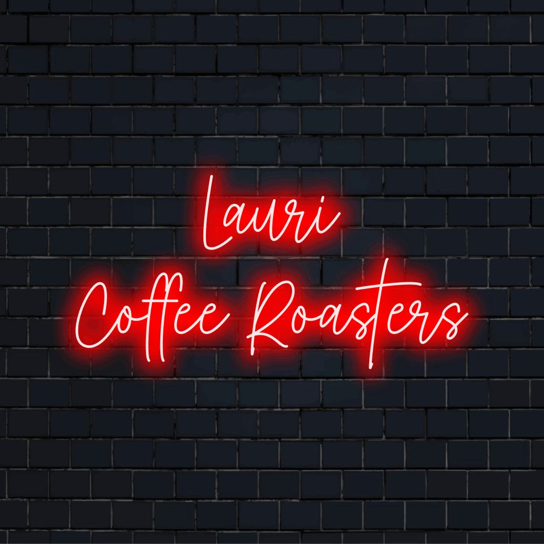 Lauri Coffee Roasters Custom Name Neon Sign, bright neon lettering against brick backdrop