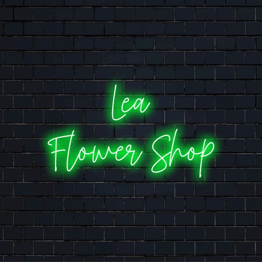 Lea Flower Shop Personalized LED Neon Sign, glowing lettering on dark brick wall