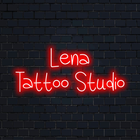 Lena Tattoo Studio Custom Name Neon Sign, bright neon lettering on dark brick wall