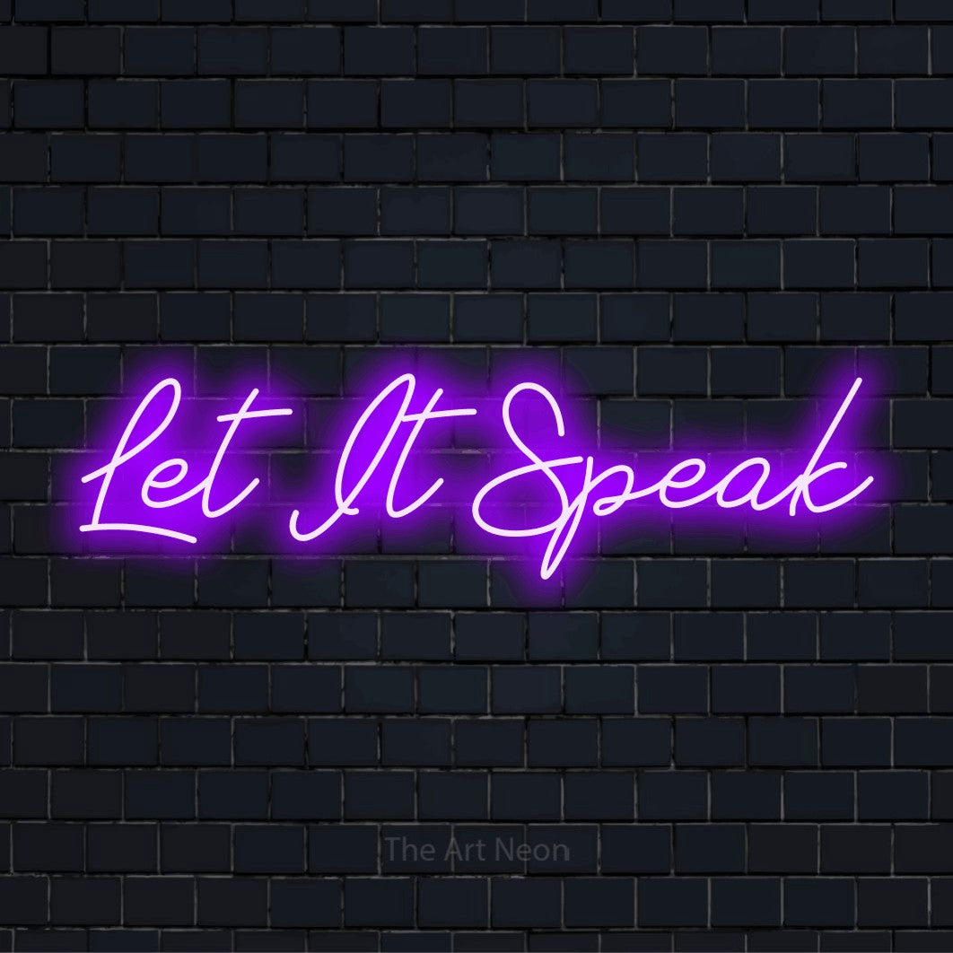 "Let It Speak" glowing LED neon sign on a black brick wall