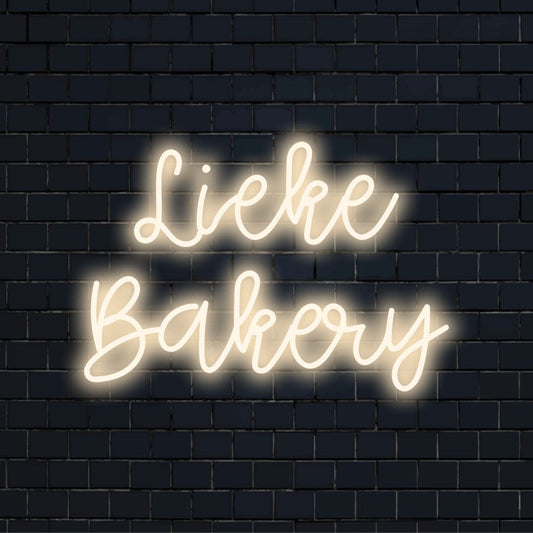 Lieke Bakery Personalized LED Neon Sign, bright neon lettering on black brick background