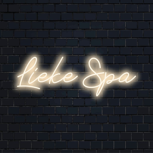 Lieke Spa Custom Name Neon Sign, glowing lettering against brick backdrop