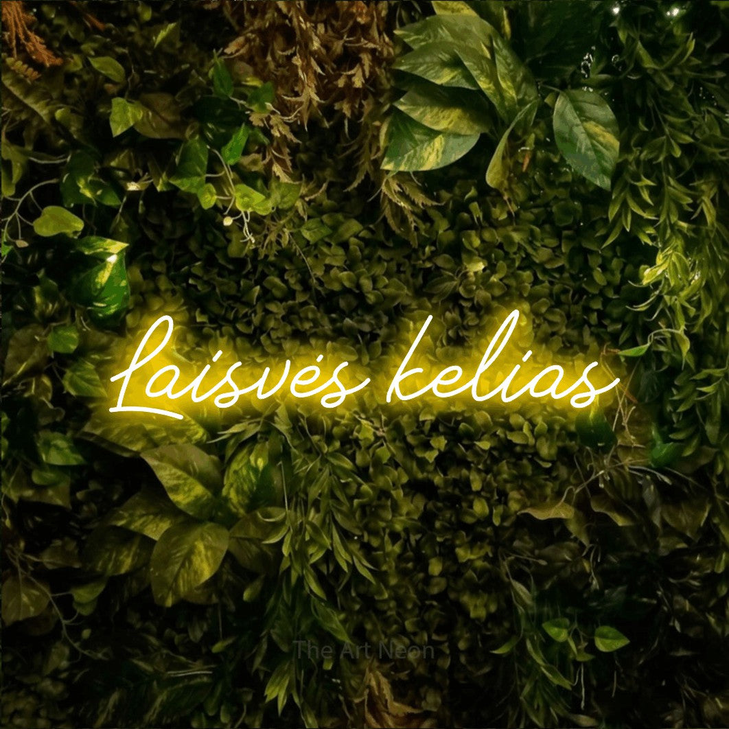 LED neon sign reading “Laisvės kelias”, arranged in a single line.