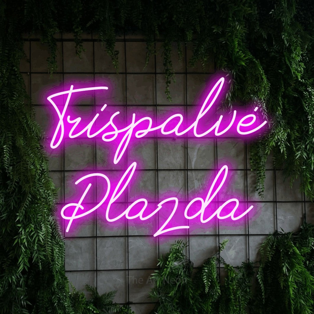 LED neon sign reading “Trispalvė Plazda”, arranged in two lines.