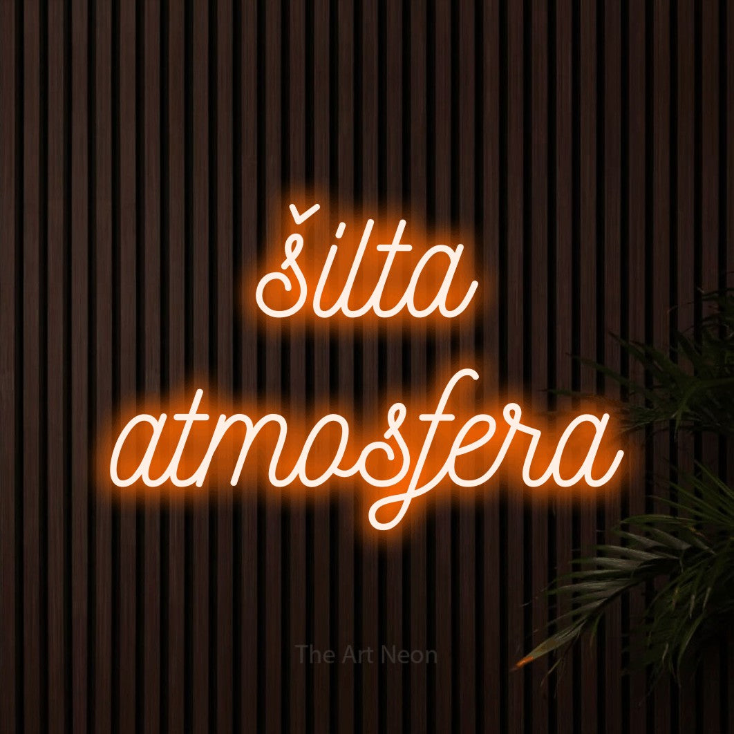 LED neon sign reading “šilta atmosfera”, arranged in two lines.