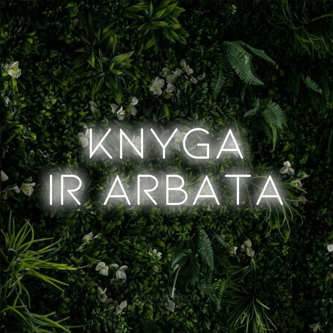 LED neon sign reading “KNYGA IR ARBATA”, arranged in two lines.