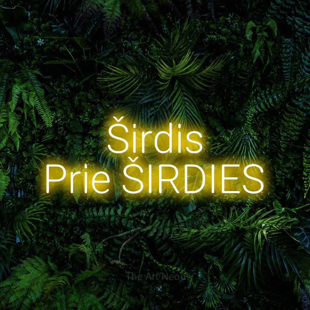 LED neon sign reading “Širdis Prie ŠIRDIES”, arranged in two lines.