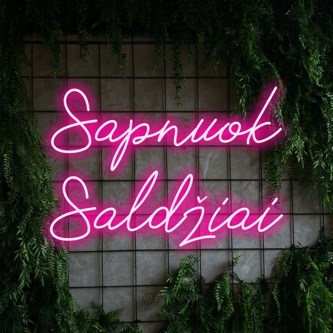 LED neon sign reading “Sapnuok Saldžiai”, arranged in two lines.