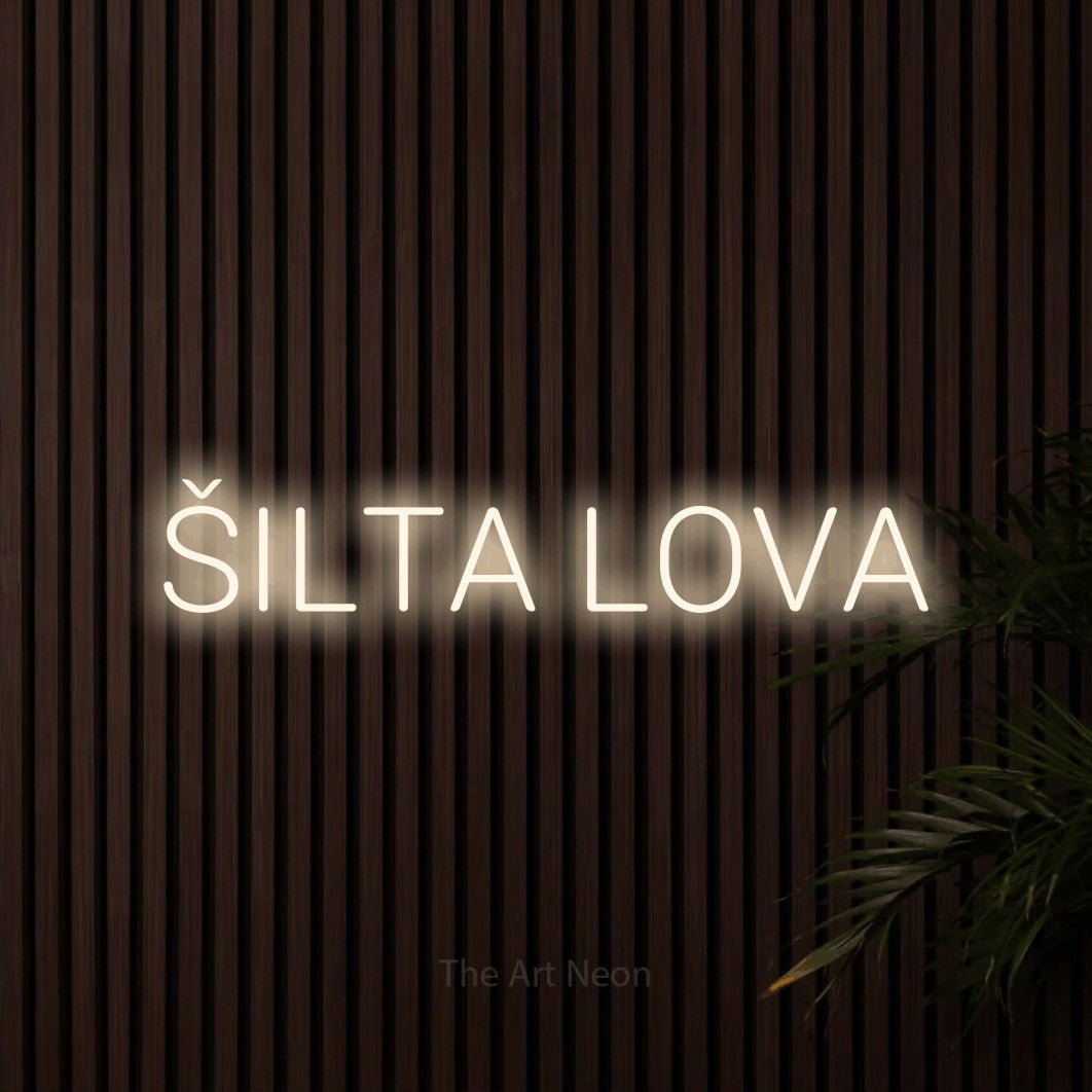 LED neon sign reading “ŠILTA LOVA”, arranged in a single line.