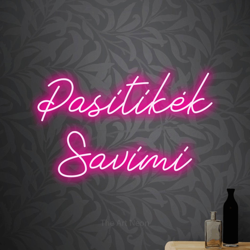 LED neon sign reading “Pasitikėk Savimi”, arranged in two lines.