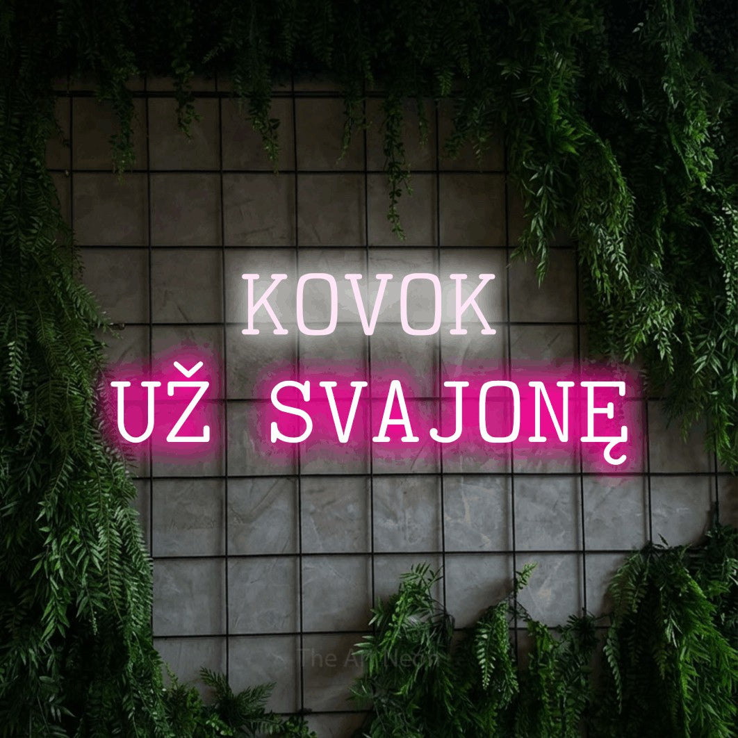 LED neon sign reading “KOVOK UŽ SVAJONĘ”, arranged in two lines.