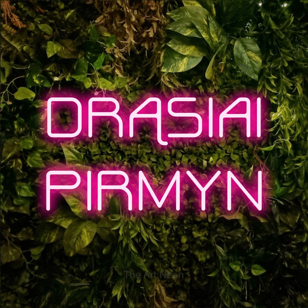 LED neon sign reading “DRĄSIAI PIRMYN”, arranged in two lines.