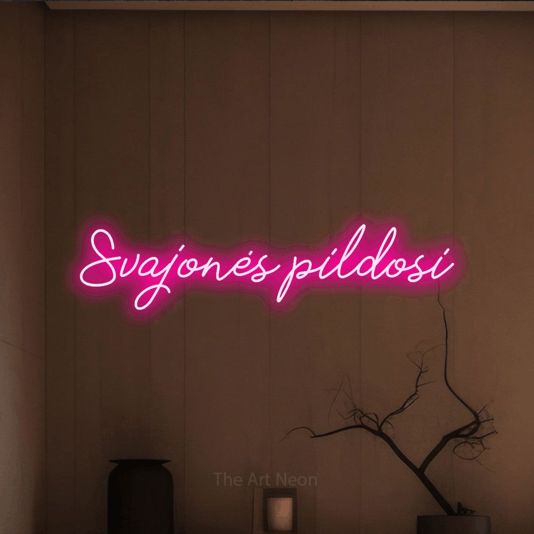 LED neon sign reading “Svajonės pildosi”, arranged in a single line.
