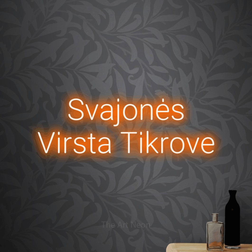 LED neon sign reading “Svajonės Virsta Tikrove”, arranged in two lines.