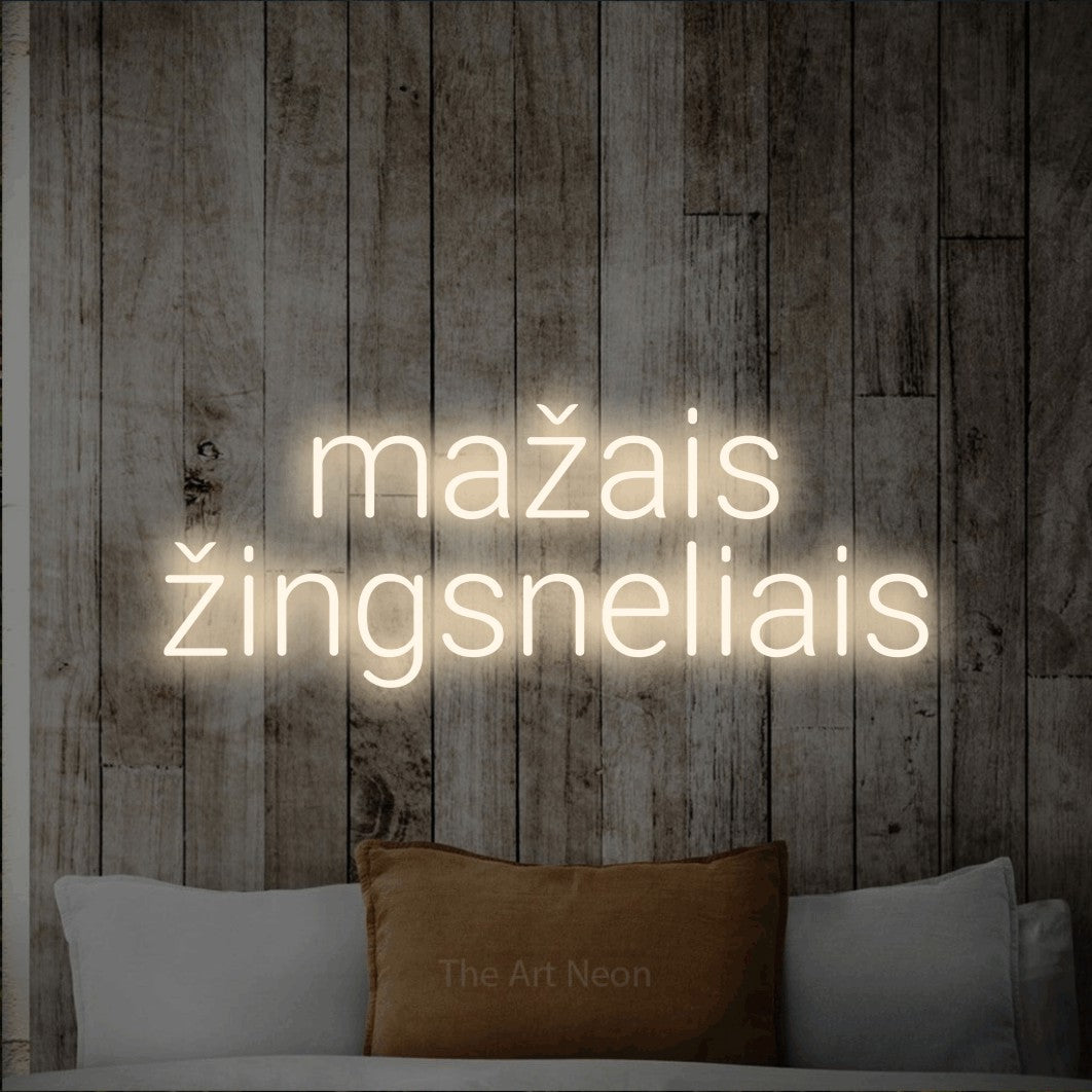 LED neon sign reading “mažais žingsneliais”, arranged in two lines.