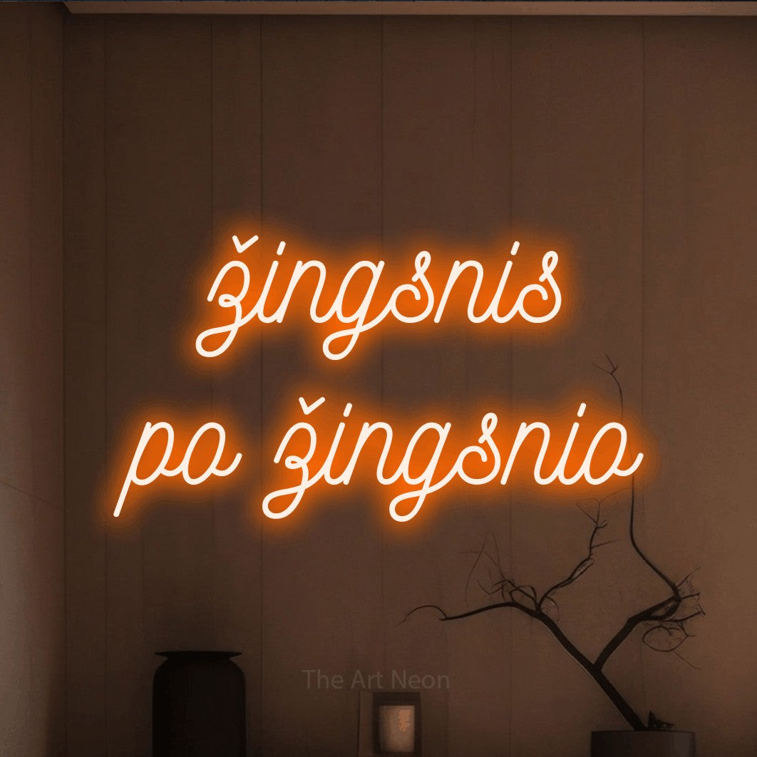 LED neon sign reading “žingsnis po žingsnio”, arranged in two lines.