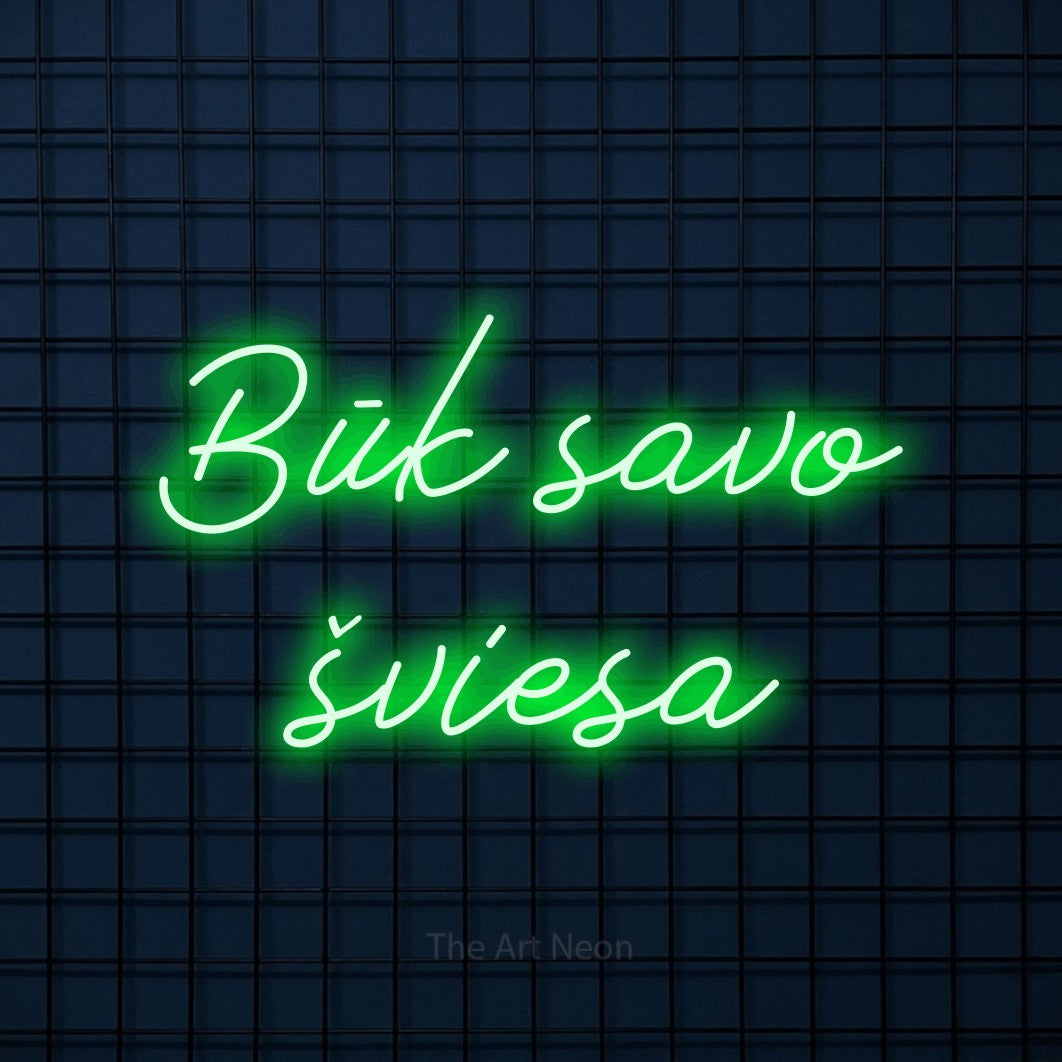 LED neon sign reading “Būk savo šviesa”, arranged in two lines.