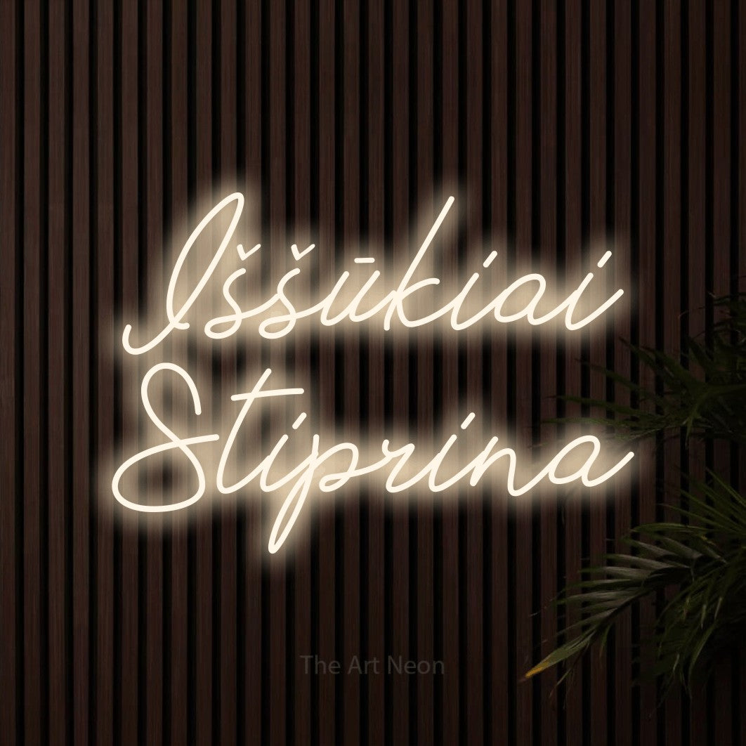 LED neon sign reading “Iššūkiai Stiprina”, arranged in two lines.