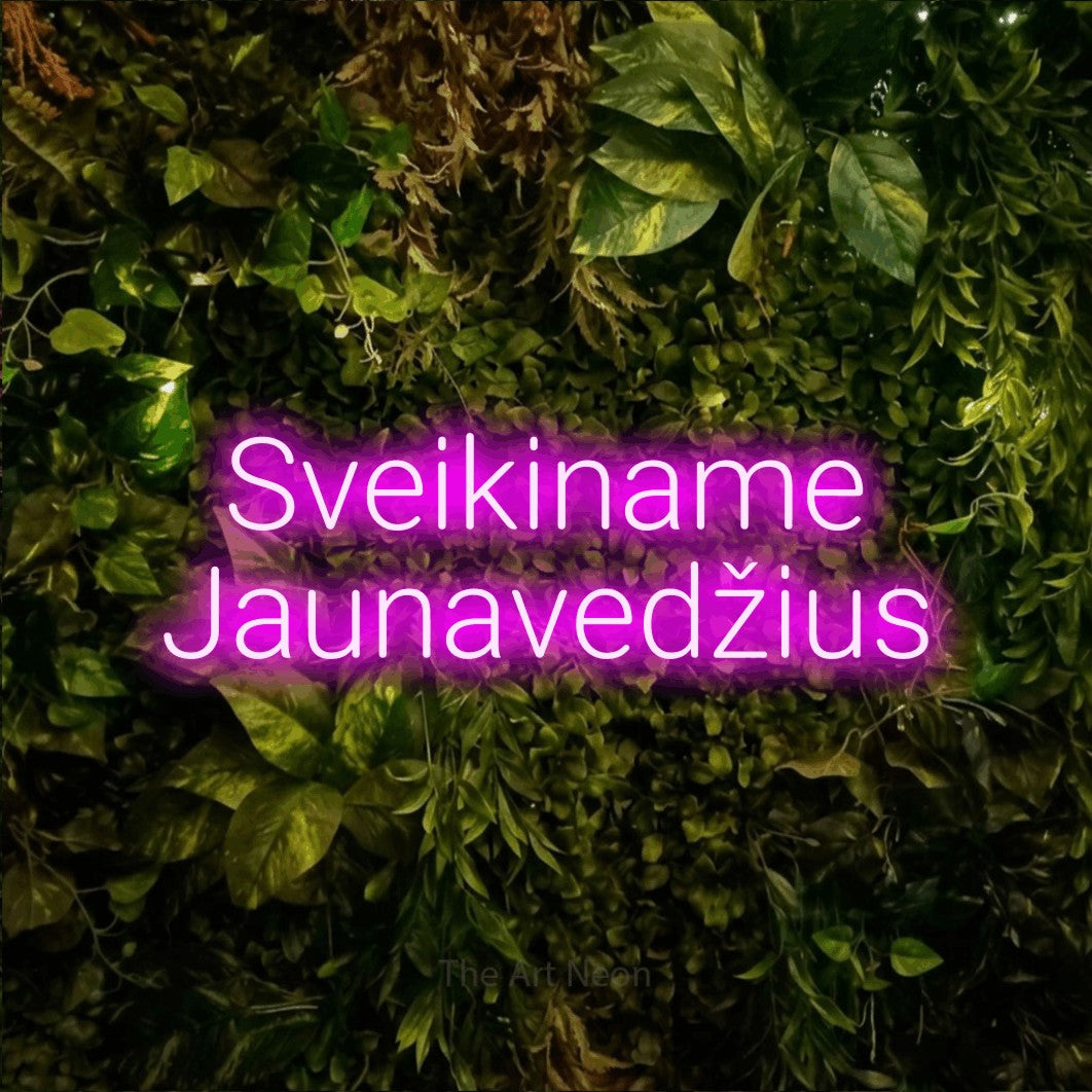 LED neon sign reading “Sveikiname Jaunavedžius”, arranged in two lines.
