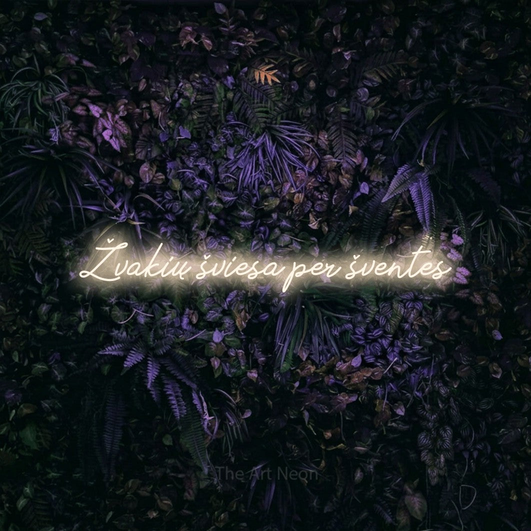 LED neon sign reading “Žvakių šviesa per šventes”, arranged in a single line.