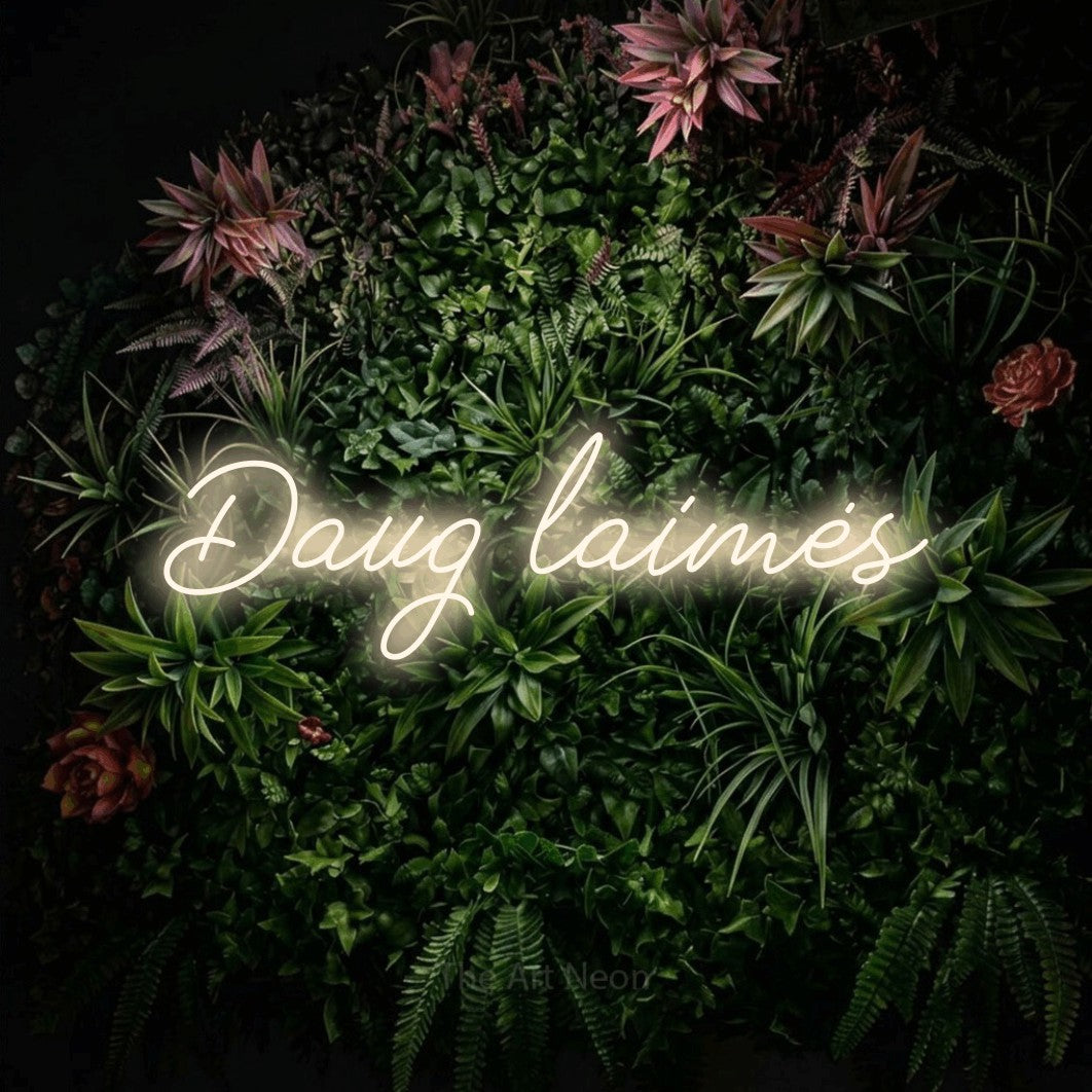 LED neon sign reading “Daug laimės”, arranged in a single line.