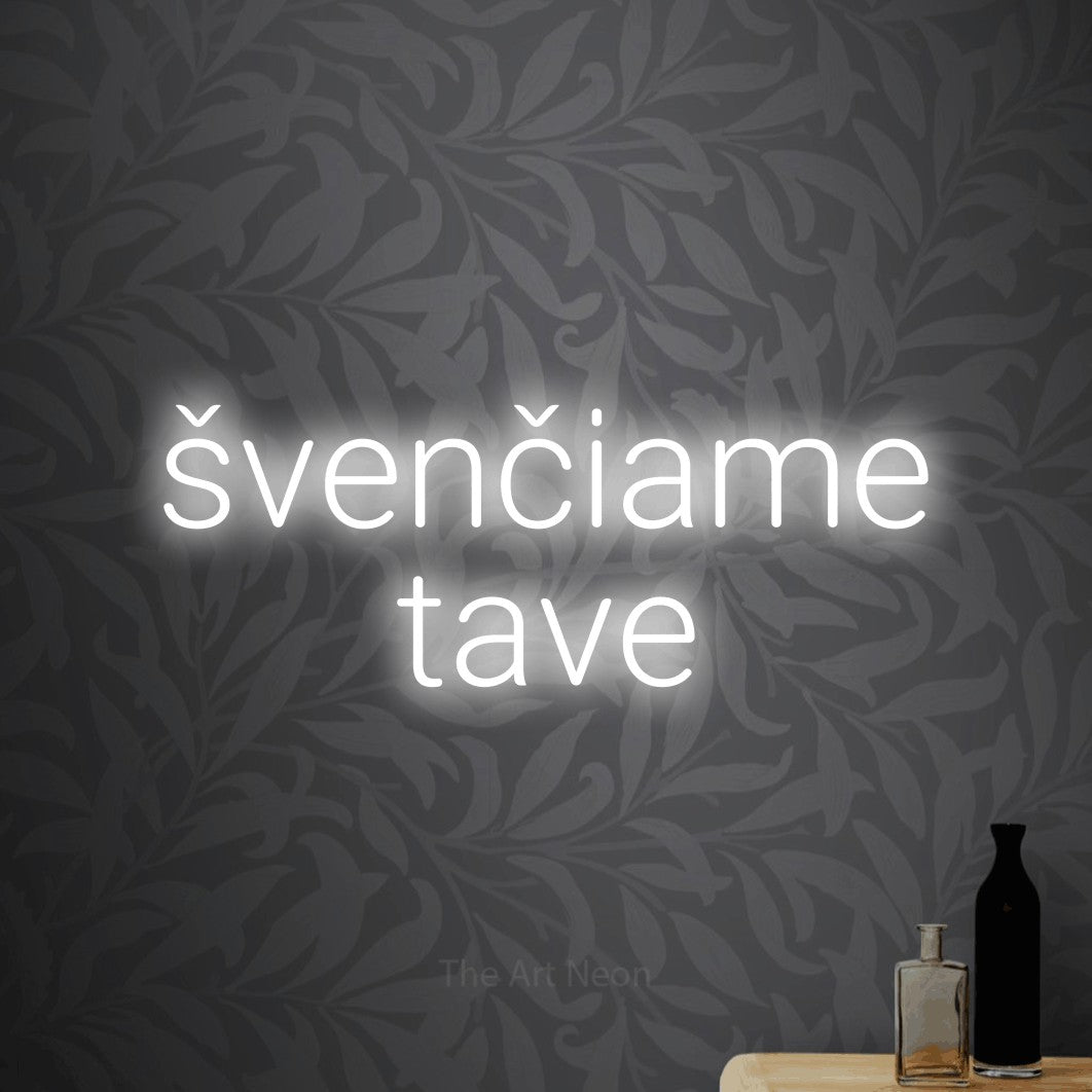 LED neon sign reading “švenčiame tave”, arranged in two lines.