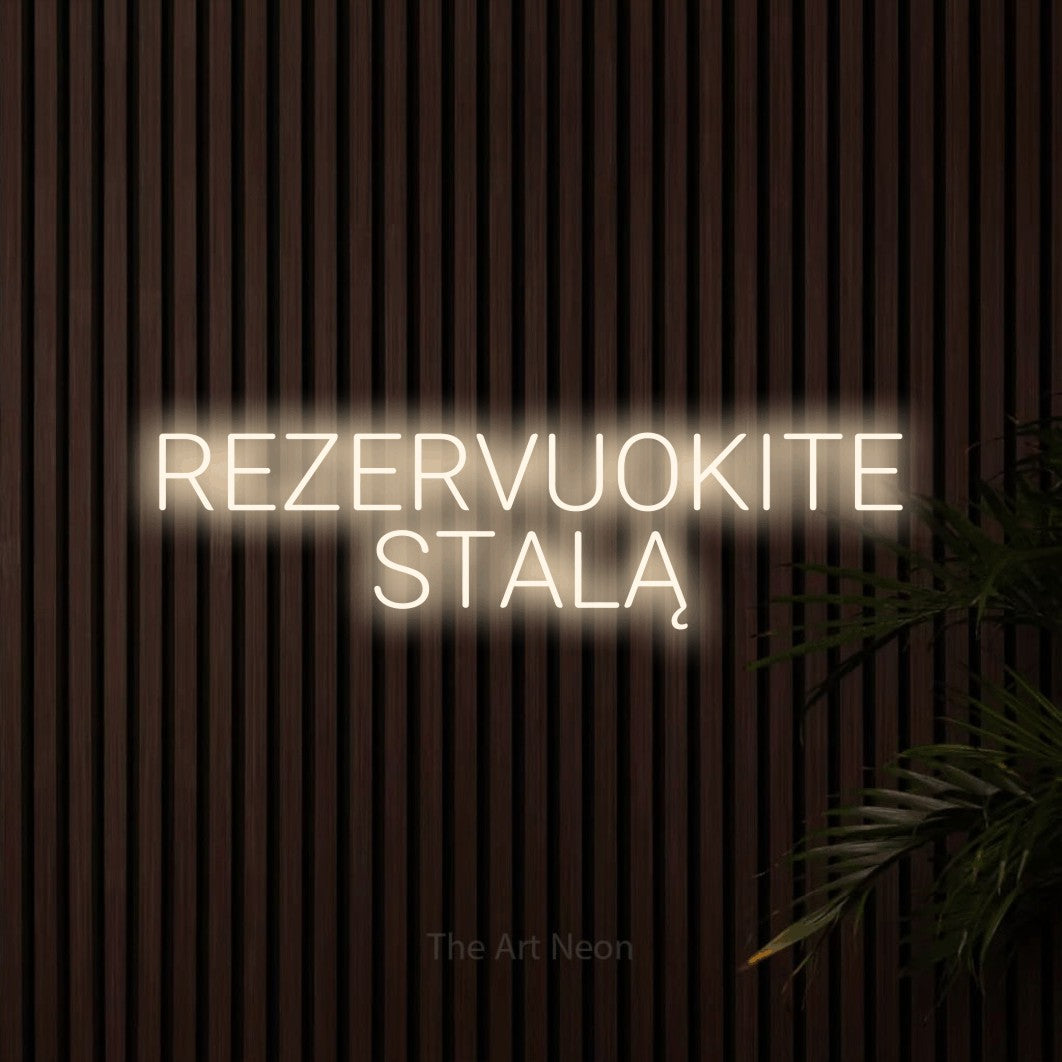 LED neon sign reading “REZERVUOKITE STALĄ”, arranged in two lines.