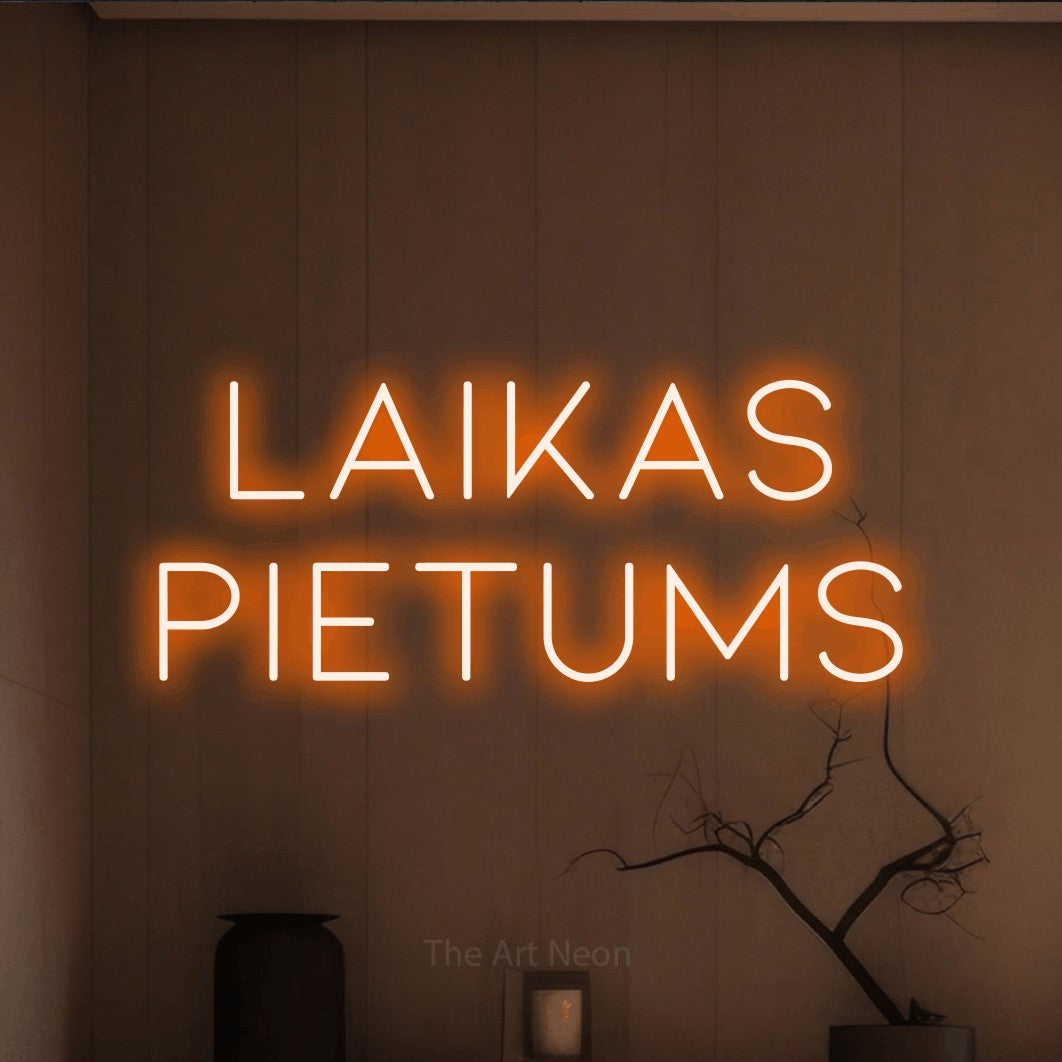 LED neon sign reading “Laikas Pietums”, arranged in two lines.