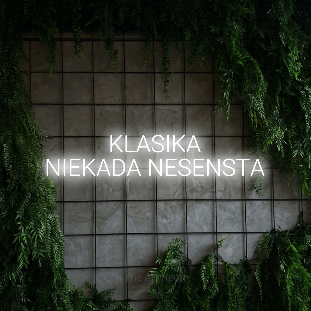 LED neon sign reading “KLASIKA NIEKADA NESENSTA”, arranged in two lines.
