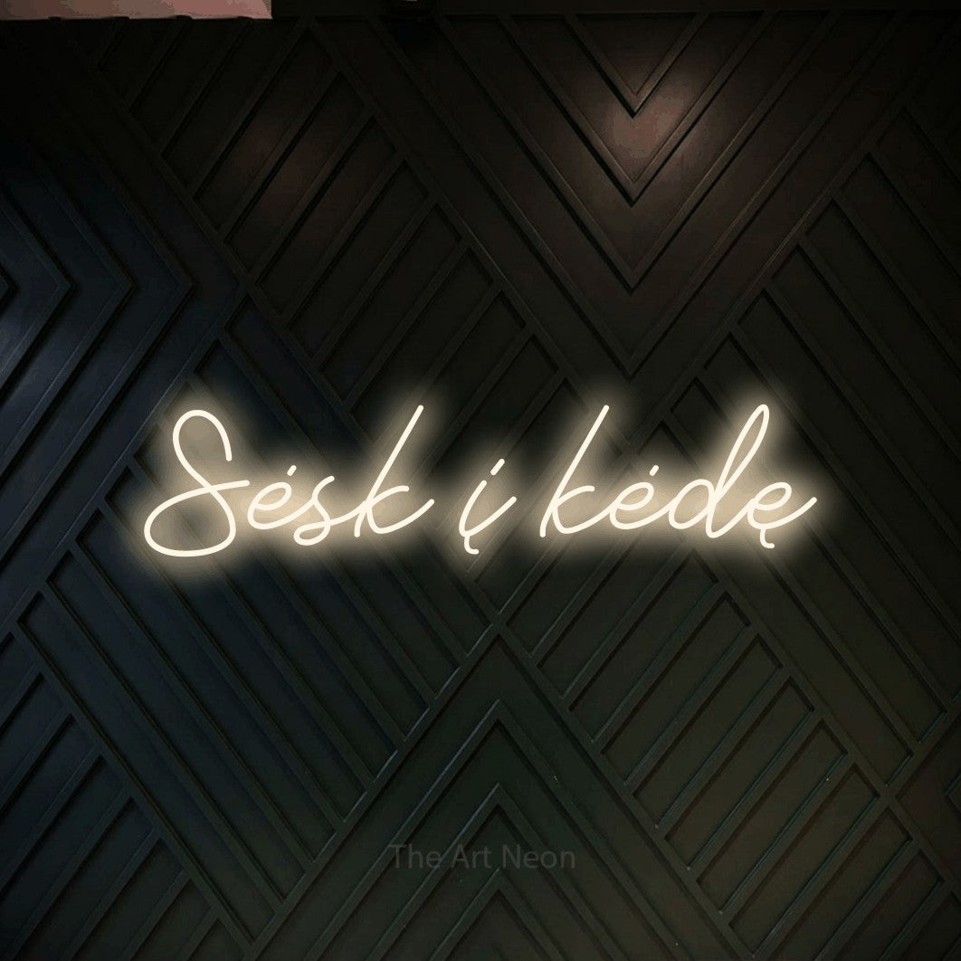 LED neon sign reading “Sėsk į kėdę”, arranged in a single line.