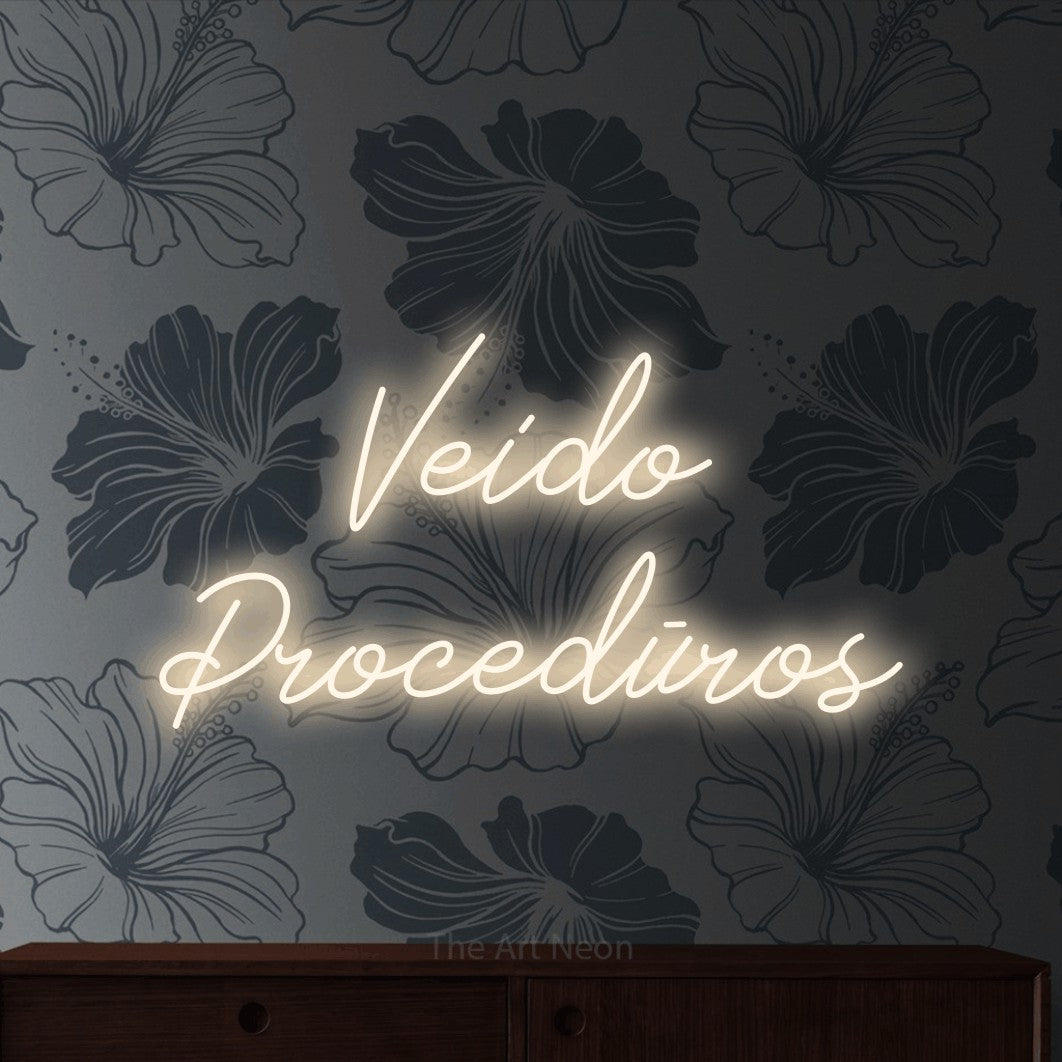 LED neon sign reading “Veido Procedūros”, arranged in two lines.
