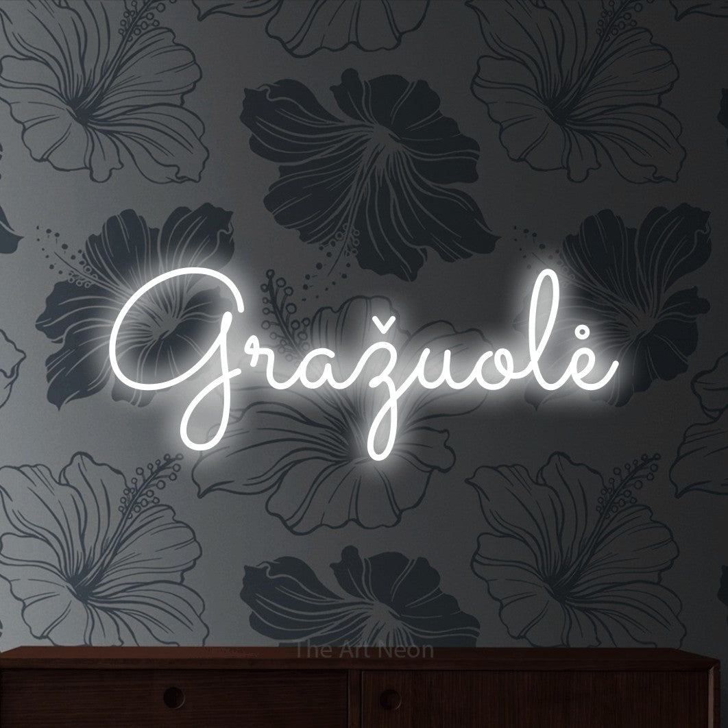 LED neon sign reading “Gražuolė”, arranged in a single line.
