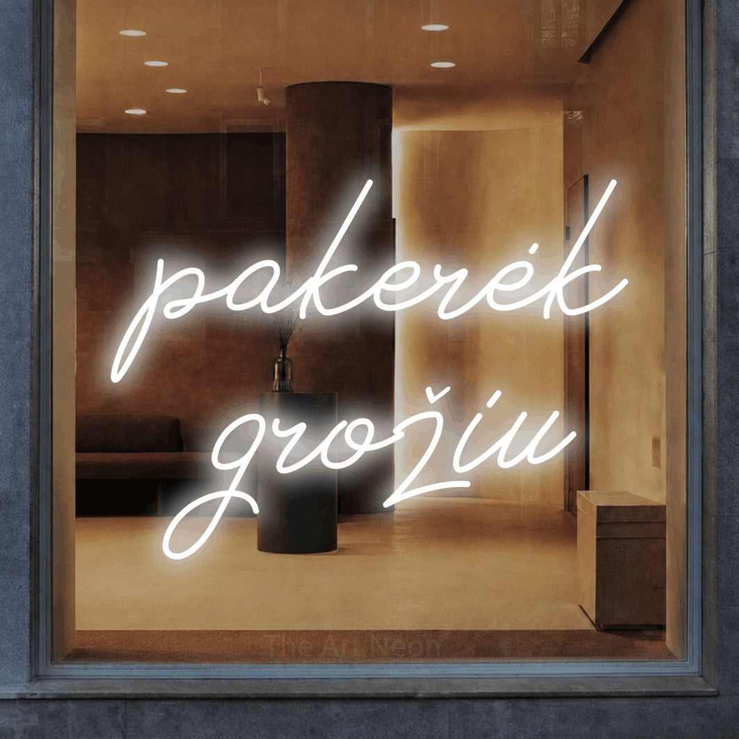 LED neon sign reading “pakerėk grožiu”, arranged in two lines.