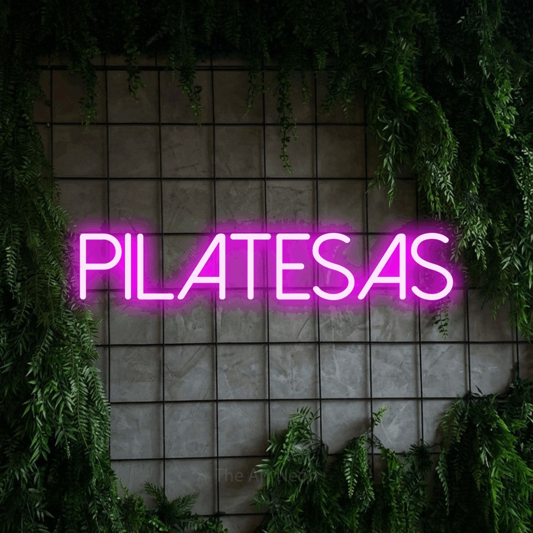 LED neon sign reading “PILATESAS”, arranged in a single line.